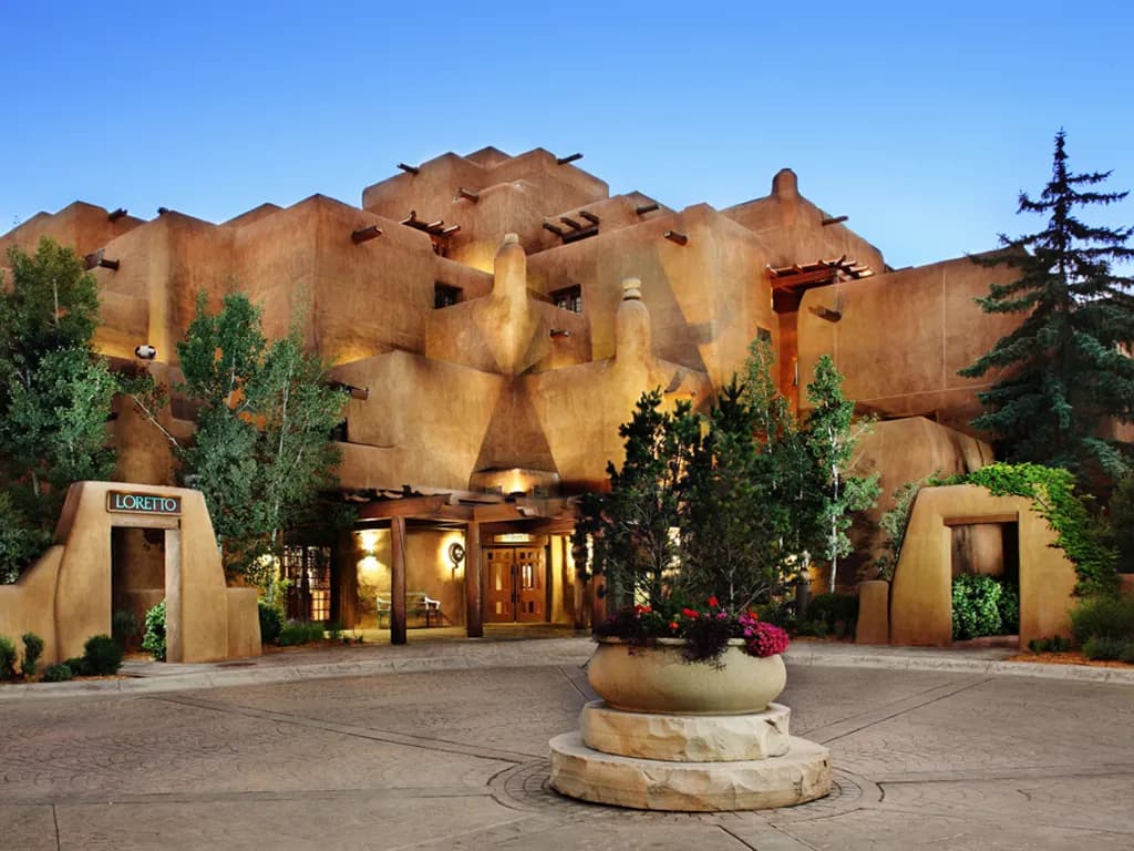 The stepped, pueblo-inspired entrance of the Inn and Spa at Loretto in downtown Santa Fe at dusk