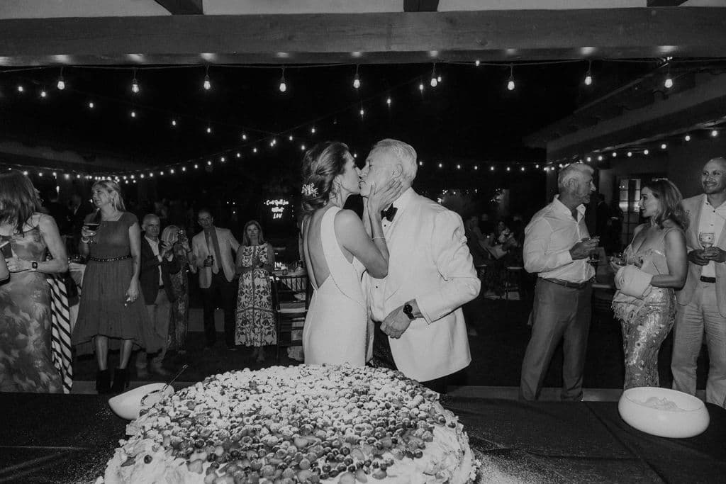 Real intimate wedding first-dance moment under string lights