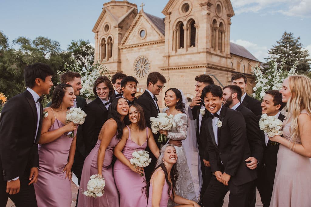 Real wedding party portrait in front of the Cathedral Basilica of St. Francis of Assisi, Santa Fe
