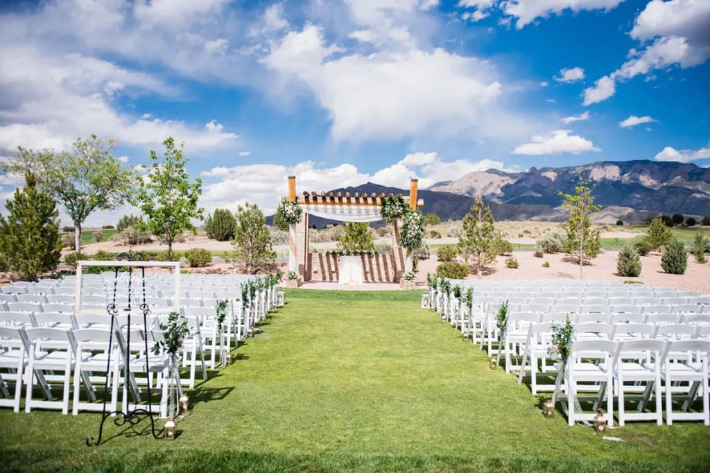 Outdoor wedding ceremony setup at The Event Center at Sandia Golf Club with the Sandia Mountains in the background
