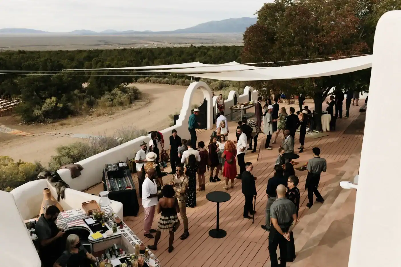 Guests gathered on The Stakeout's adobe deck atop Outlaw Hill overlooking the Taos desert mesa and mountains
